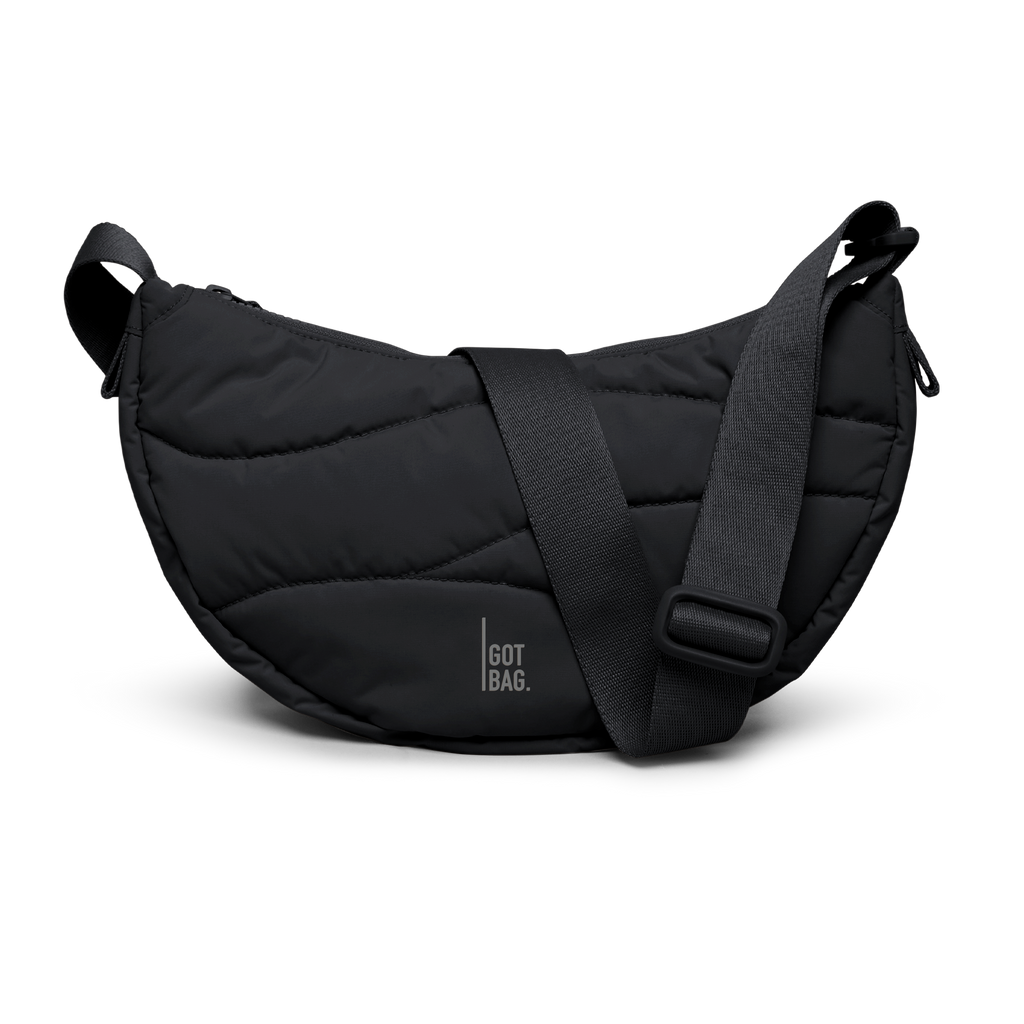 WAVY PUFFER MOON BAG Tasche in black (Schwarz) als Studioaufnahme in Frontansicht.